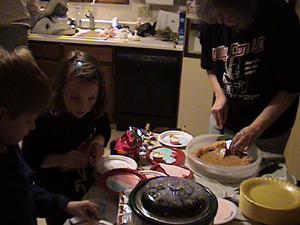 Connor Taurins and Bea Pfeiffer help Karen Peiffer serve up Bea's pumpkin pie course